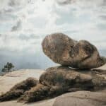 brown rock formation under white clouds during daytime